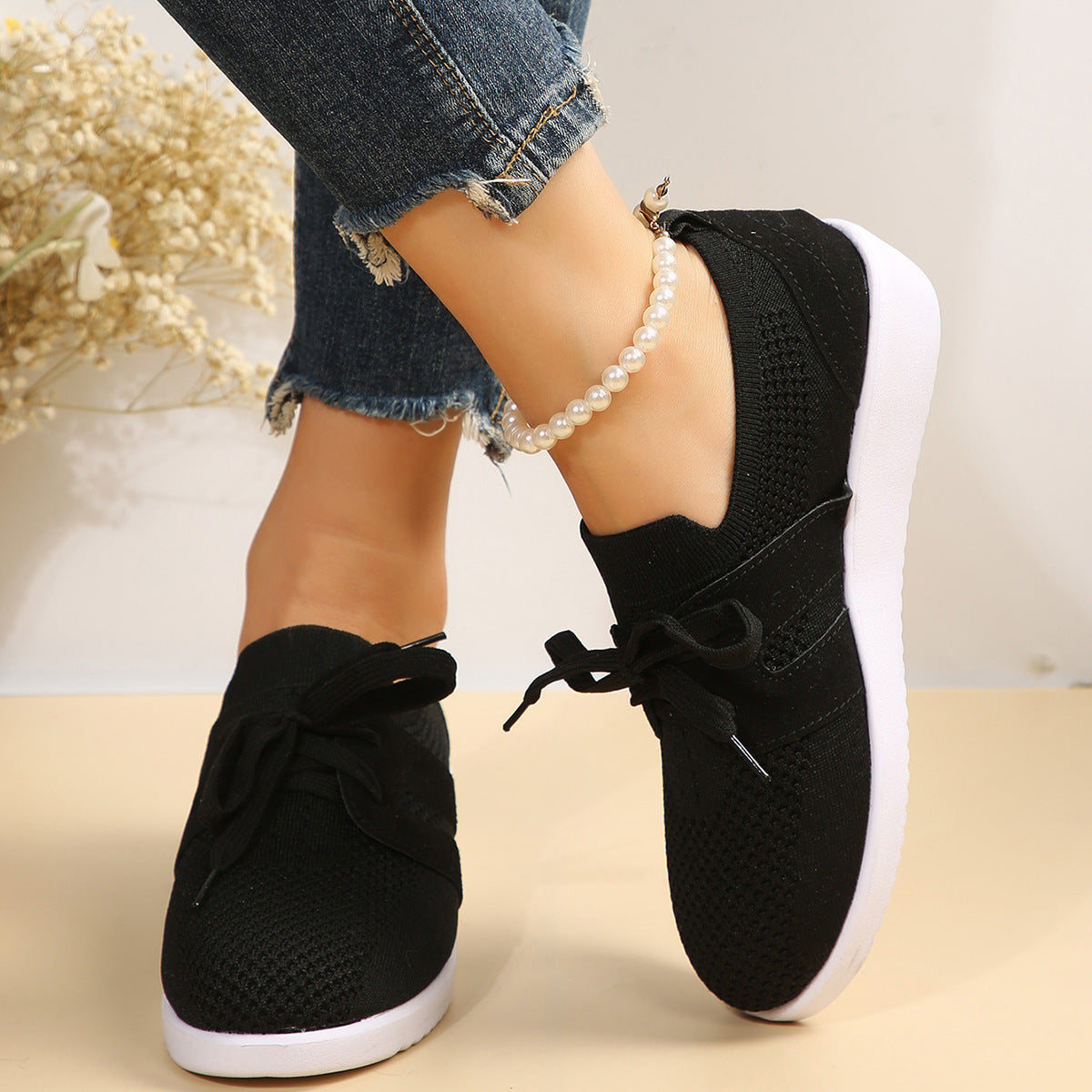 Lightweight knit sneaker with wide laces and flexible sole